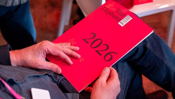 Ein Mann hält die erste Ausgabe des Journals "The Elephant" auf dem Schoß